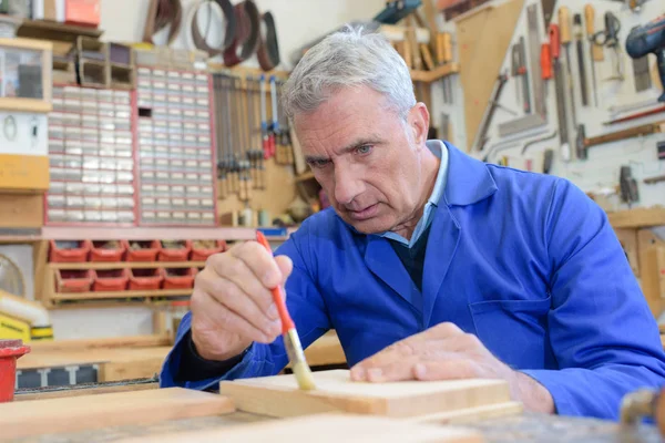 Senior arbeitet in Holzlackiererei — Stockfoto