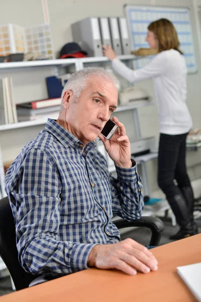 Ανώτερος άνθρωπος παίρνει μια κλήση στο γραφείο του — Φωτογραφία Αρχείου