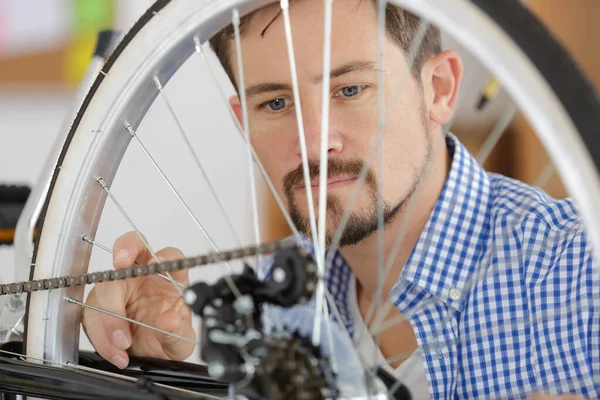 Homme fixation roue de vélo en magasin — Photo