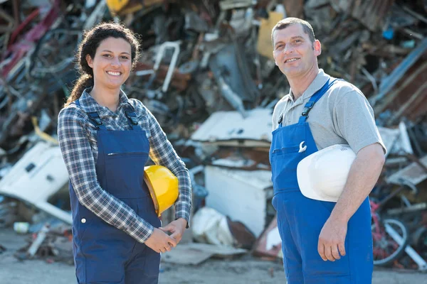 Feminino e masculino junkyard trabalhador olhando para a câmera — Fotografia de Stock