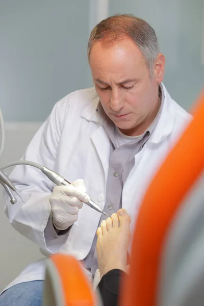 podiatry doctor treating patients foot