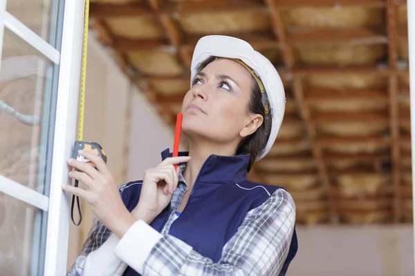 Mulher construtor moldura da janela de medição — Fotografia de Stock