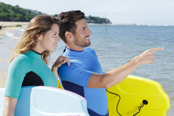 Young couple of bodyboard surfers Stock Picture