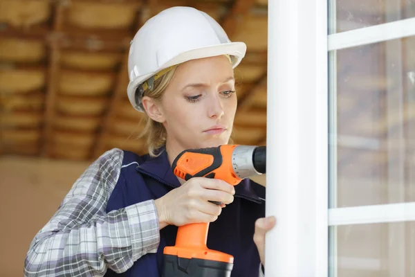 Young woman with a drill — Stock Photo, Image