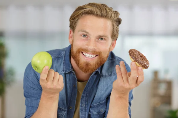 Choosing between donut and apple — Stock Photo, Image