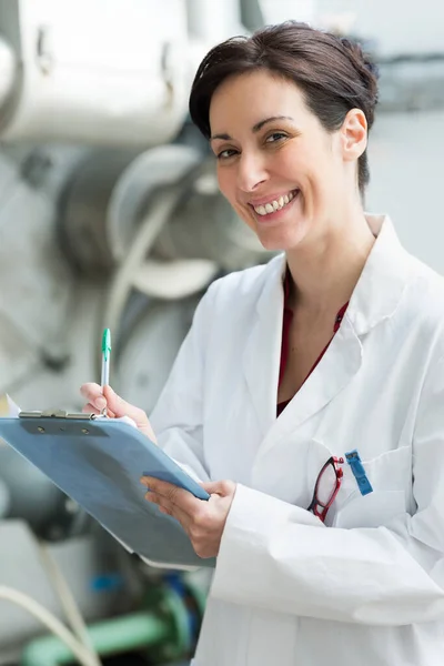 Doctor recording information on clipboard — Stock Photo, Image