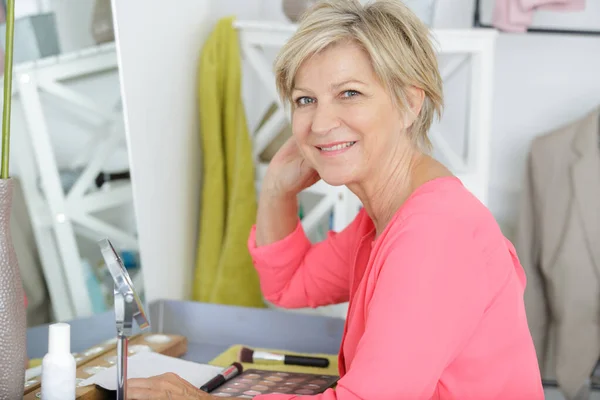 Mulher idosa ao lado de make-up — Fotografia de Stock