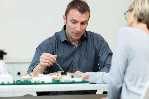 Portrait of designers looking at plans — Stock Photo, Image