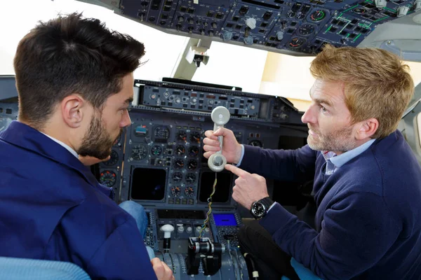 Male engineer on cockpit phone — Stock Photo, Image