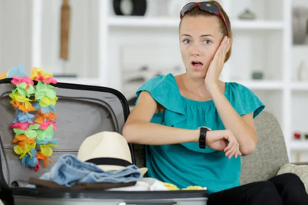 Vrouw verpakking koffer in paniek als ze zich realiseert de tijd — Stockfoto