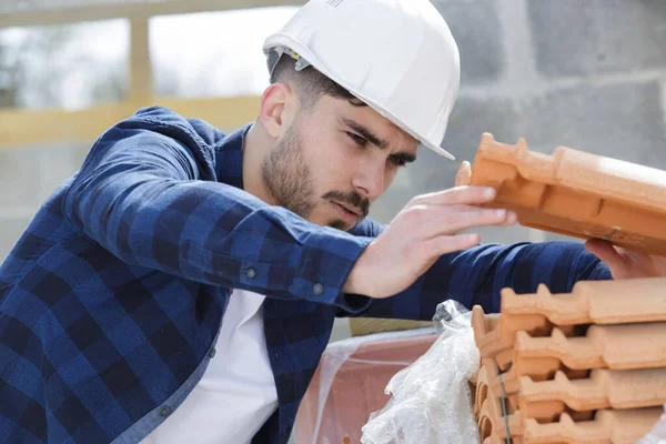Builder preparing for roof tiles replacement — Stock Photo, Image