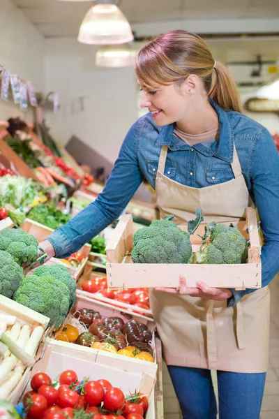 Mulher compra um brócolis em uma loja — Fotografia de Stock