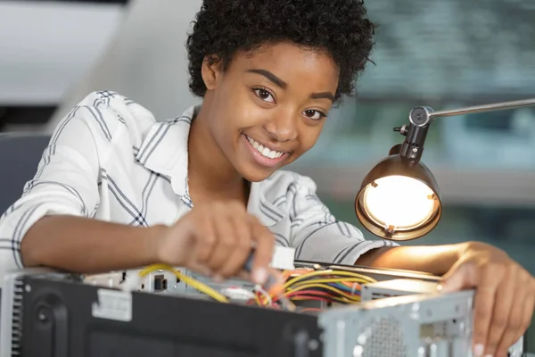 Gelukkig vrouwelijke pc-technicus solderen een chip van een desktop computer — Stockfoto