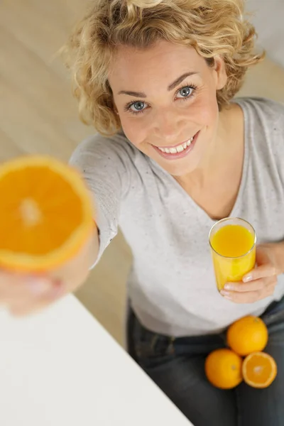 Beautiful young woman with glass of orange juice — Stock Photo, Image