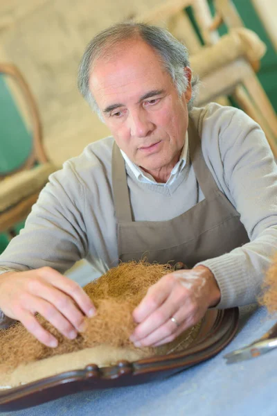 Artisan dans son atelier de menuiserie avec chaise — Photo