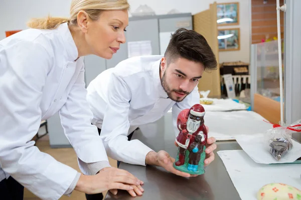 They are making chocolate santa claus — Stock Photo, Image