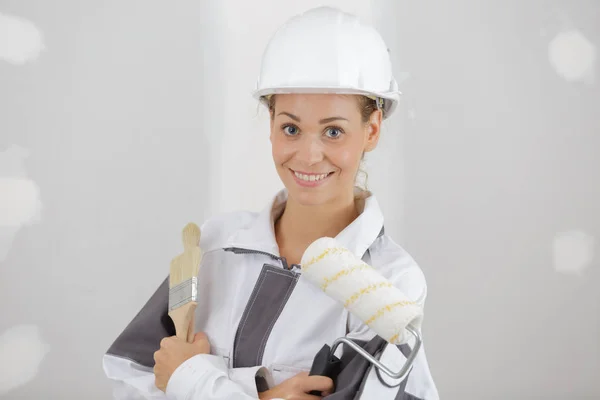 Vrouwelijke schilder met penseel in werkplaats — Stockfoto