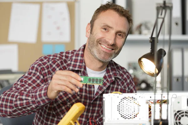 Técnica sorrindo segurando um circuito — Fotografia de Stock