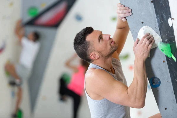 Strong man spending day in climbing gym — Stock Photo, Image