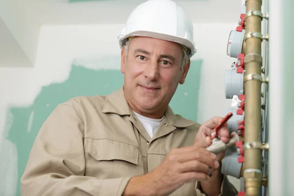 Plumber technician works with water meter — Stock Photo, Image