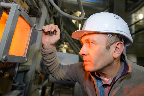 Welder checking the flame in the furnace — ストック写真