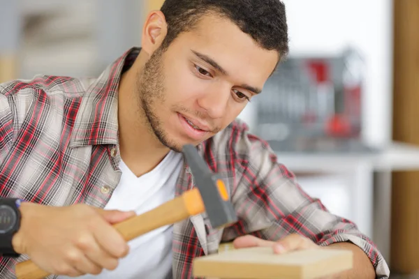 Man building a house and workimg with hammer and wood Royalty Free Stock Images