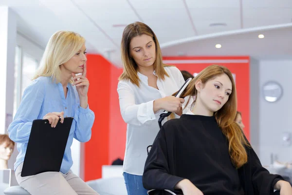 Estudante menina no cabeleireiro aprendizagem como cortar o cabelo — Fotografia de Stock