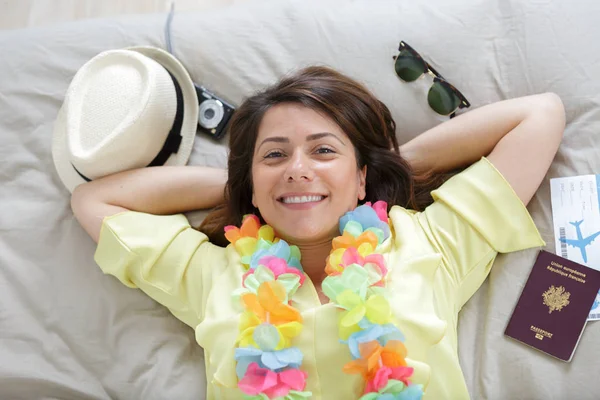 Woman laying on bed before going on holidays — Stock Photo, Image