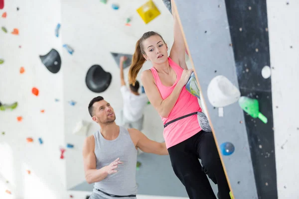 Nervous lady on indoor climbing wall — Stock Photo, Image