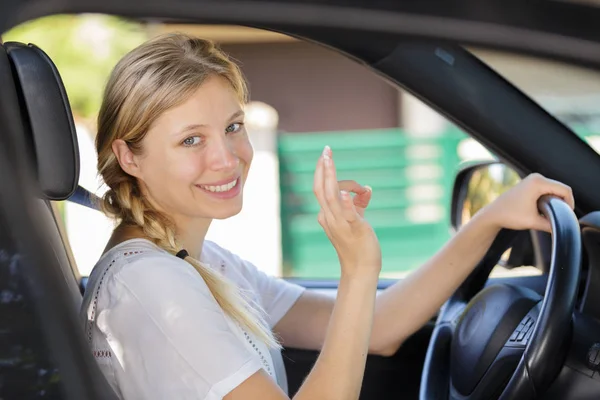 Young female driver showing perfect sign — Stock Photo, Image