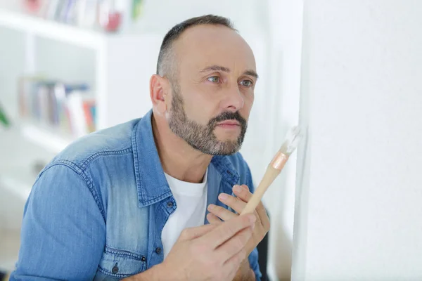 El hombre está pintando la pared — Foto de Stock