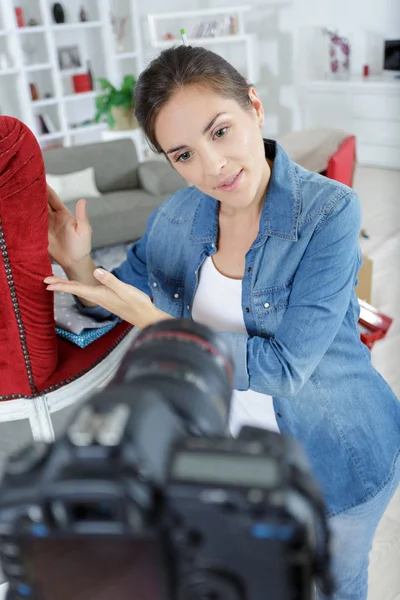 Woman doing a blog about upholstering a chair — Stock Photo, Image