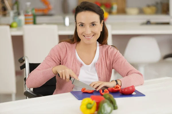 Disabled woman cutting bell pepper — Stock Photo, Image