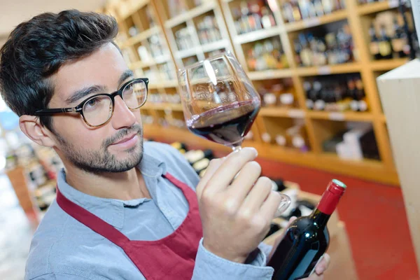 Sommelier looking at a glass of wine — ストック写真
