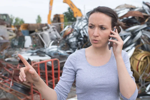 Young landfill manager on the phone — ストック写真