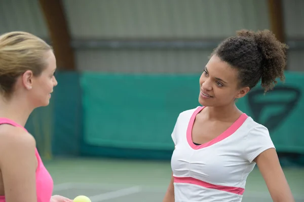 Zwei fröhliche sportliche Tennisspielerinnen im Gespräch — Stockfoto