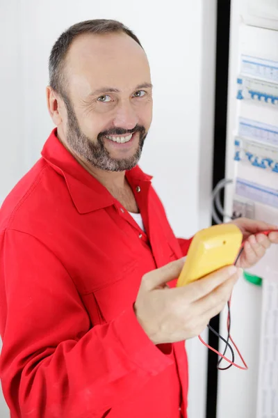 Electrician works with electronic equipment — Stock Photo, Image