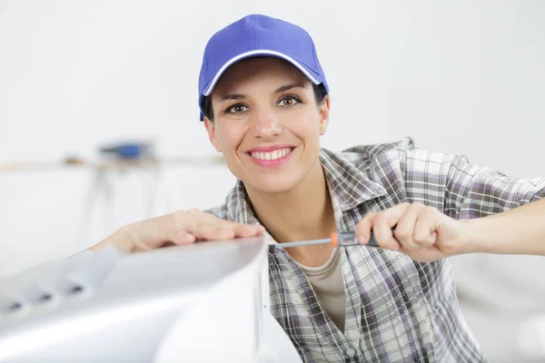 A female technician working indoors — Stok fotoğraf