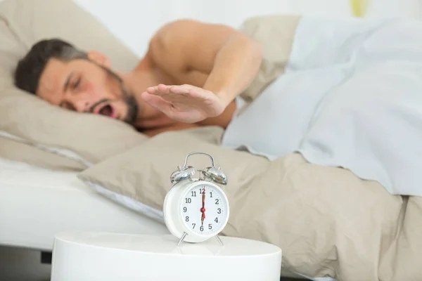 Handsome Tired Man Turning Alarm Clock — Stock Photo, Image