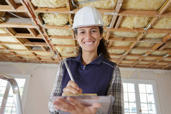 Young Female Builder Holding Paper Clipboard — Stock Photo, Image