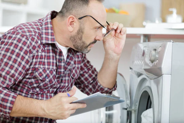 Geschockter Verärgerter Mann Schaut Auf Waschmaschine — Stockfoto