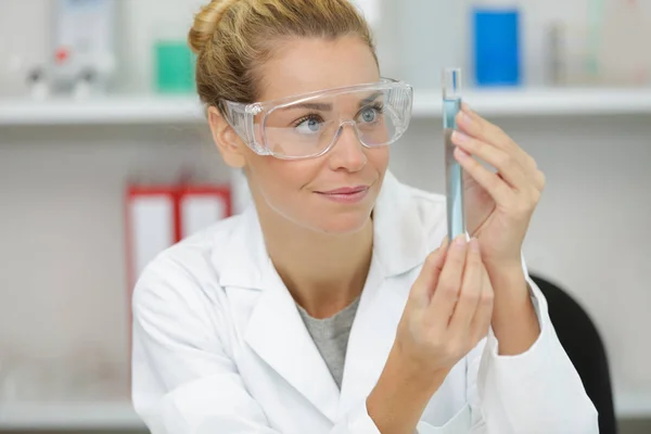 Smiling Young Female Doctor Holding Flask Royalty Free Stock Images