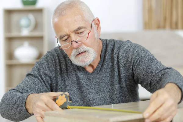 Mature Man Measuring Furniture Home — Stock Photo, Image