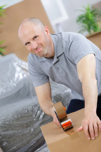 Young Caucasian Man Using Duct Tape Packing Box — Stock Photo, Image