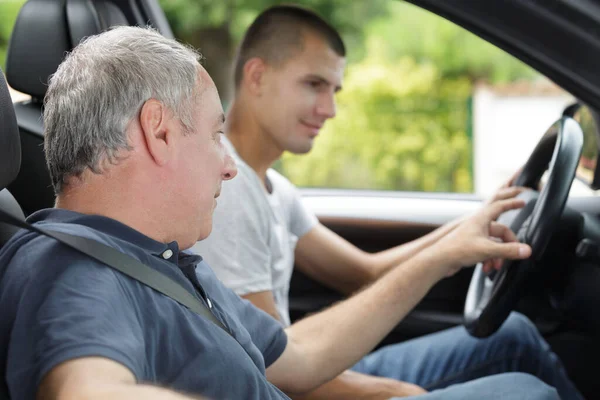 Father Giving His Son Driving Lesson Royalty Free Stock Images