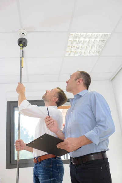 Man Controlling Fire Detectors — Stock Photo, Image