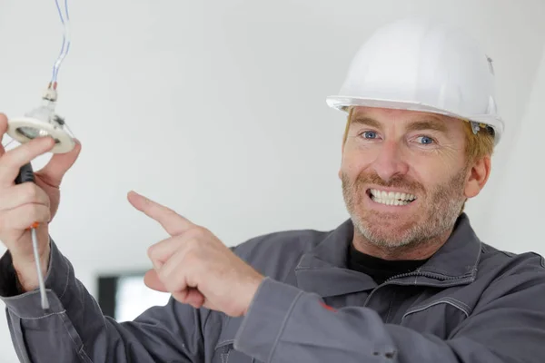Electrician Pointing Spot Light — Stock Photo, Image