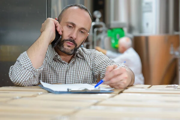 Homem Inclinado Prancheta Pilha Caixas Falando Por Telefone — Fotografia de Stock