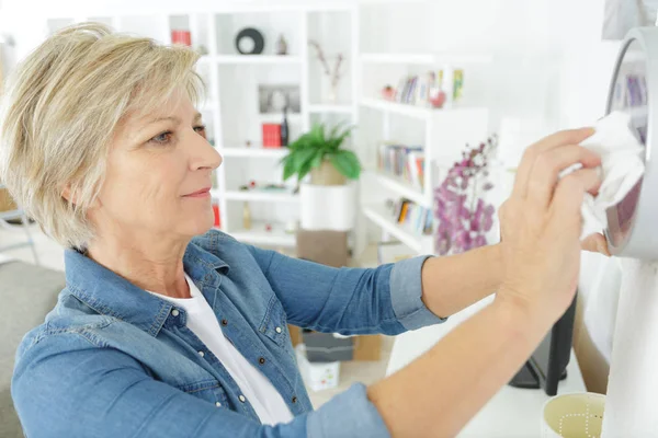 Elderly Senior Woman Cleaning Clock — Stock Photo, Image