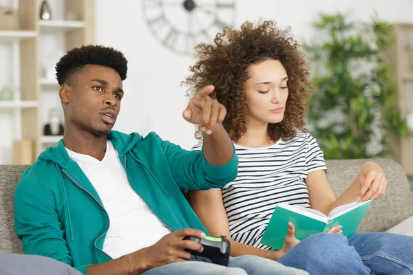 Mann Spielt Videospiele Und Frau Liest Buch — Stockfoto